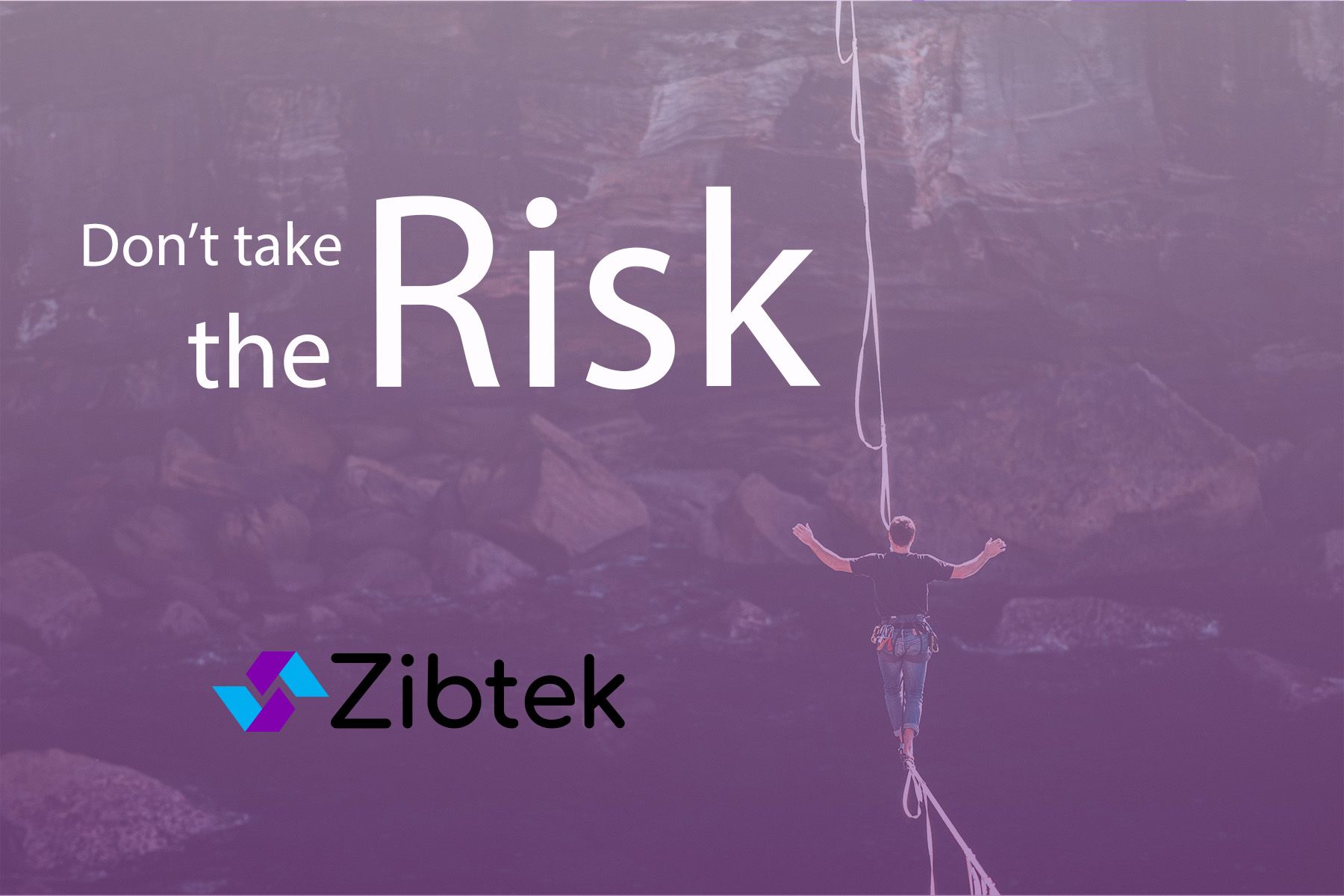Rock climber harnessed in by rope safely secured
